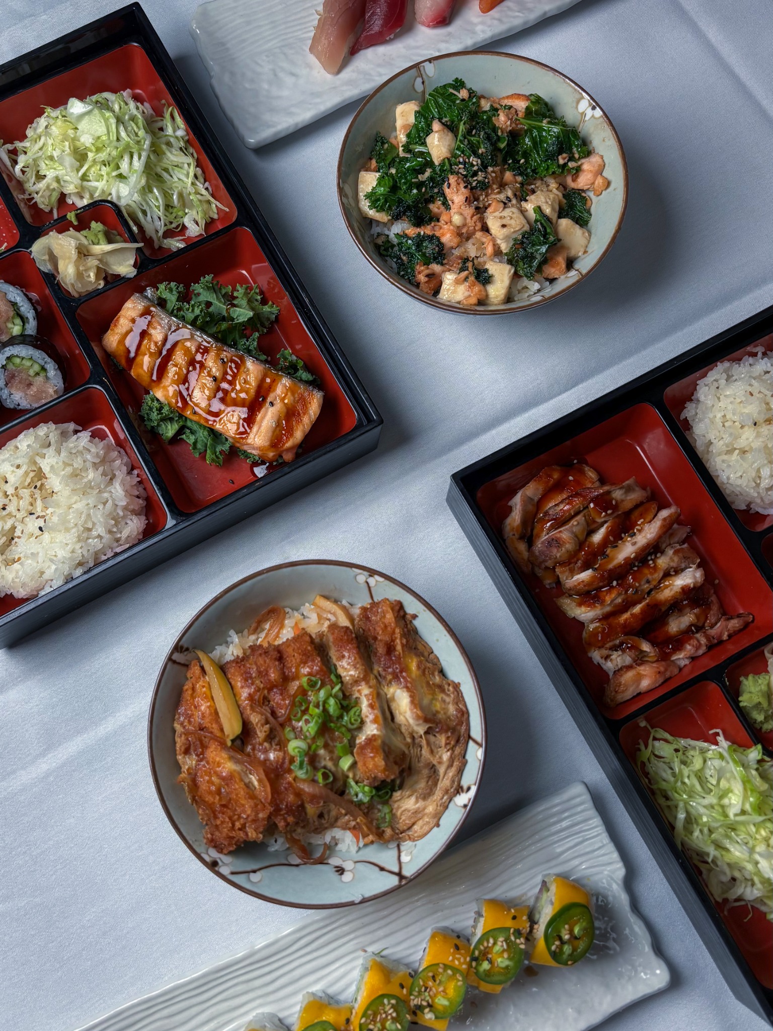 Overhead food photography featuring sushi, bento boxes, and Japanese dishes