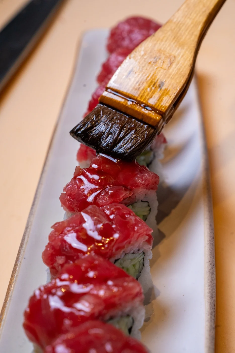 Glaze brushed over a freshly prepared sushi roll