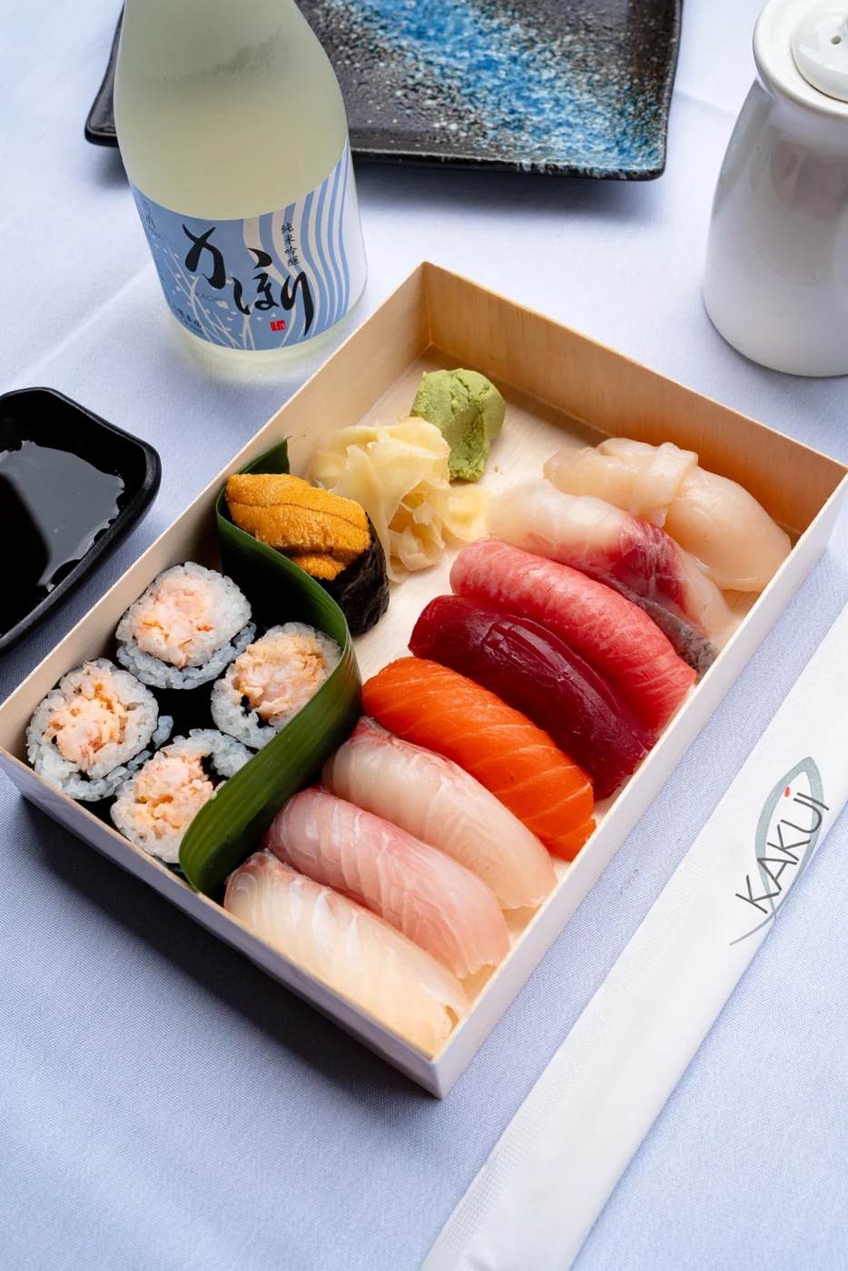 Nigiri sushi selection with sake and fresh garnishes